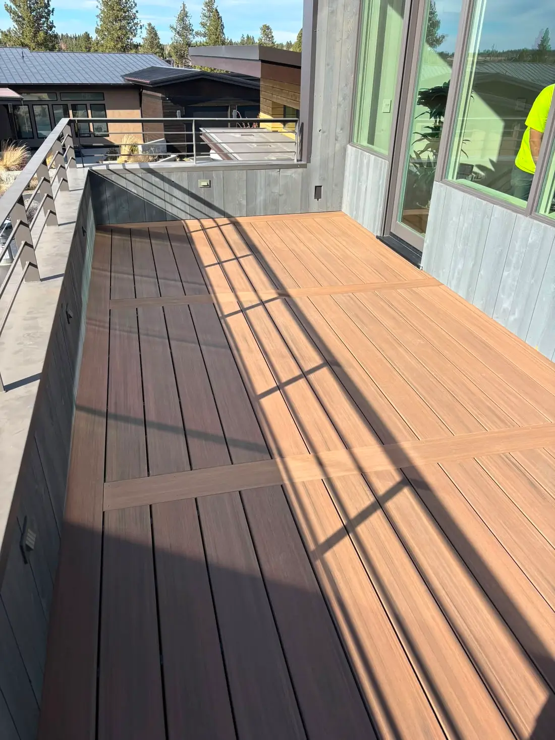 Two-tone composite deck with picture-frame border on a modern home